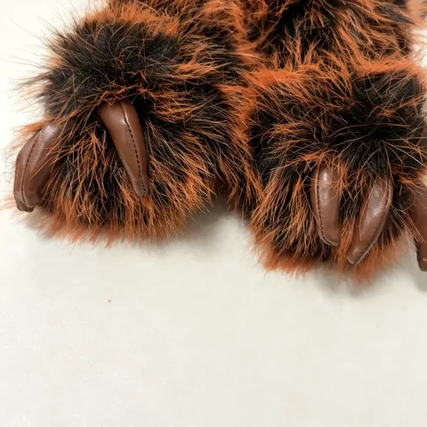 Close-up of Nappy's PU leather-look claws and fine stitching against the shaggy two-tone fur